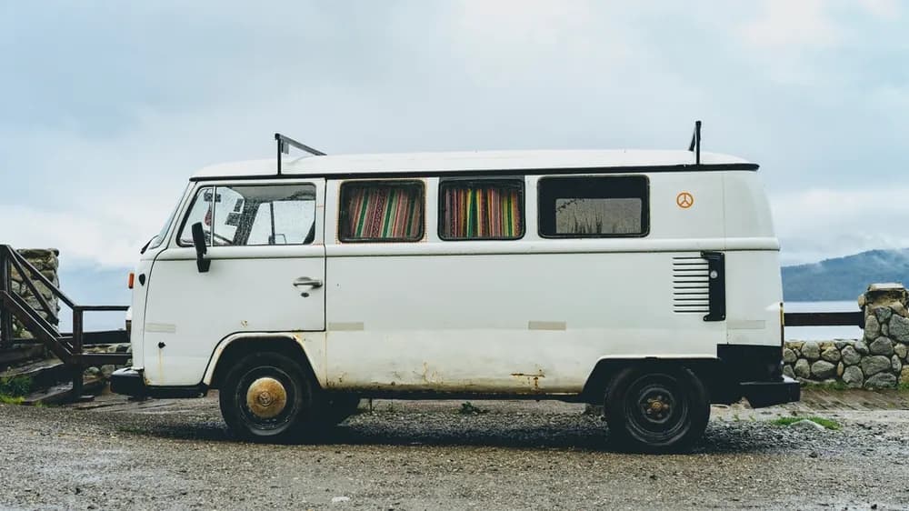A white service van parked by the road