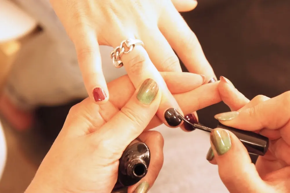 A manicurist painting nails